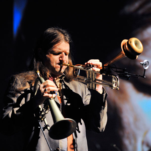 Das Bild zeigt den Tiroler Jazz Trompeter Franz Hackl beim Musizieren.