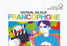 Festival des frankophonen Films in Tunis und Sousse / ÖB Tunis Das gezeichnete Bild zeigt eine bunte Figur, welche mit Popcorn und Saftbecher vor einer Regieklappe steht