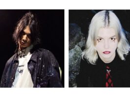 Kenji Araki und Antonia XM in Tokio / Kulturforum Tokio Den Künstler Kenji Araki und die Künstlerin Antonia XM. Kenji Araki blickt mit leicht gesenktem Haupt in die Kamera, sein langes schwarzes Haar hängt ins Gesicht. Er trägt eine schwarze Jeansweste mit Farbspritzern und ein weißes Shirt, ebenfalls mit Farbspritzern. Der Hintergrund ist Dunkel, von hinten strahlt den Künstler Licht an. Die Künstlerin Antonia XM blickt von unten hinauf in die Kamera, ihr Haar ist weißblond, ihre Haut sehr hell, ihr Make-up weist unter jedem Auge eine schwarze Träne auf, ihre Lippen sind dunkelrot. Sie trägt eine schwarze Bluse und eine rot-schwarze Krawatte. Der Hintergrund besteht aus Felsen.