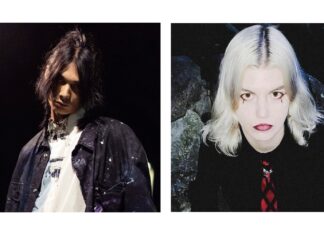 Kenji Araki und Antonia XM in Tokio / Kulturforum Tokio Den Künstler Kenji Araki und die Künstlerin Antonia XM. Kenji Araki blickt mit leicht gesenktem Haupt in die Kamera, sein langes schwarzes Haar hängt ins Gesicht. Er trägt eine schwarze Jeansweste mit Farbspritzern und ein weißes Shirt, ebenfalls mit Farbspritzern. Der Hintergrund ist Dunkel, von hinten strahlt den Künstler Licht an. Die Künstlerin Antonia XM blickt von unten hinauf in die Kamera, ihr Haar ist weißblond, ihre Haut sehr hell, ihr Make-up weist unter jedem Auge eine schwarze Träne auf, ihre Lippen sind dunkelrot. Sie trägt eine schwarze Bluse und eine rot-schwarze Krawatte. Der Hintergrund besteht aus Felsen.