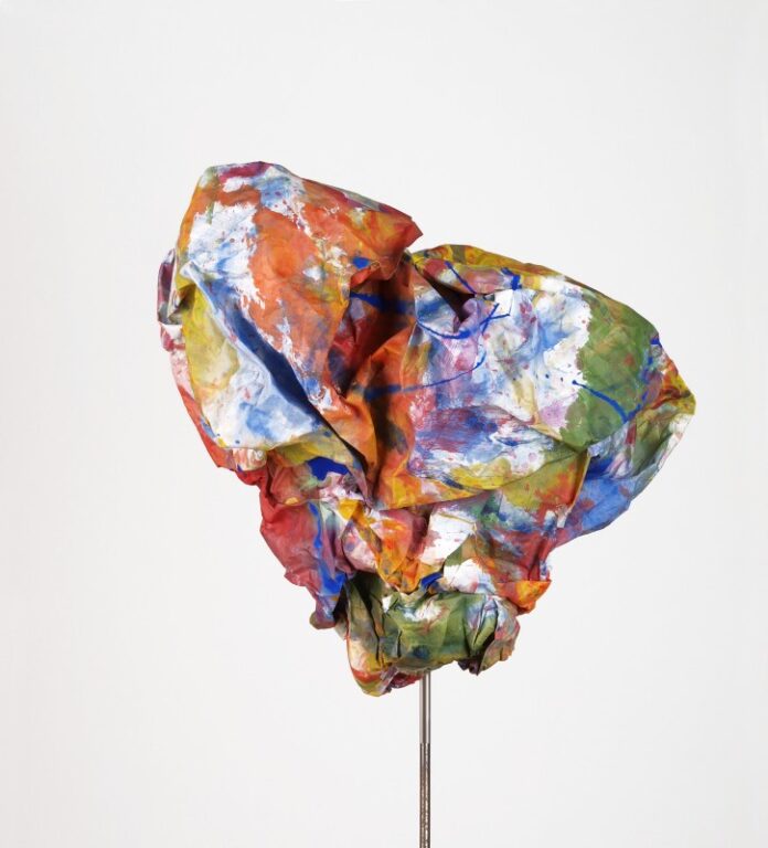 Das Bild zeigt ein aus handgemachtem Papier erzeugtes Werk der Künstlerin Beate Winkler. Es handelt sich um eine große Papierkugel, die bunt bemalt ist.