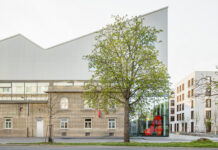 Wiener Impulse für Palermo / Kulturforum Rom Das Bild zeigt eine moderne, langgestreckte Industriehalle mit heller Fassade.